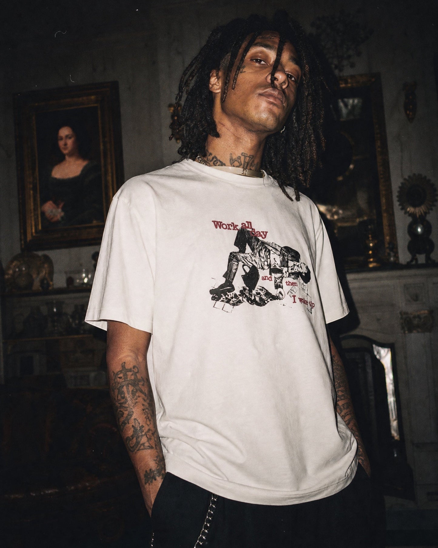 ANTIPROMINDのヴィンテージ風グラフィックがプリントされたオフホワイトの天竺コットンTシャツを着用した男性