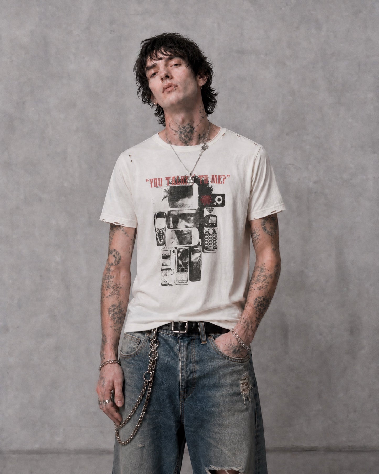 ANTIPROMINDのダメージ加工が施されたヴィンテージ風グラフィックTシャツを着用した男性モデル