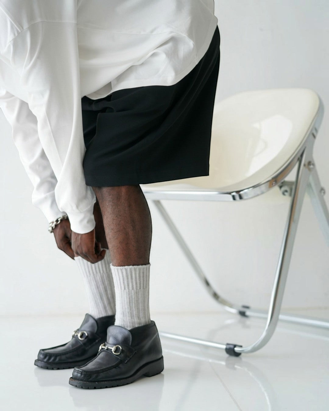 BASIS Pima Cotton DRAGO L/S T-Shirt in black. A man wears the long-sleeve shirt with black shorts and grey socks.