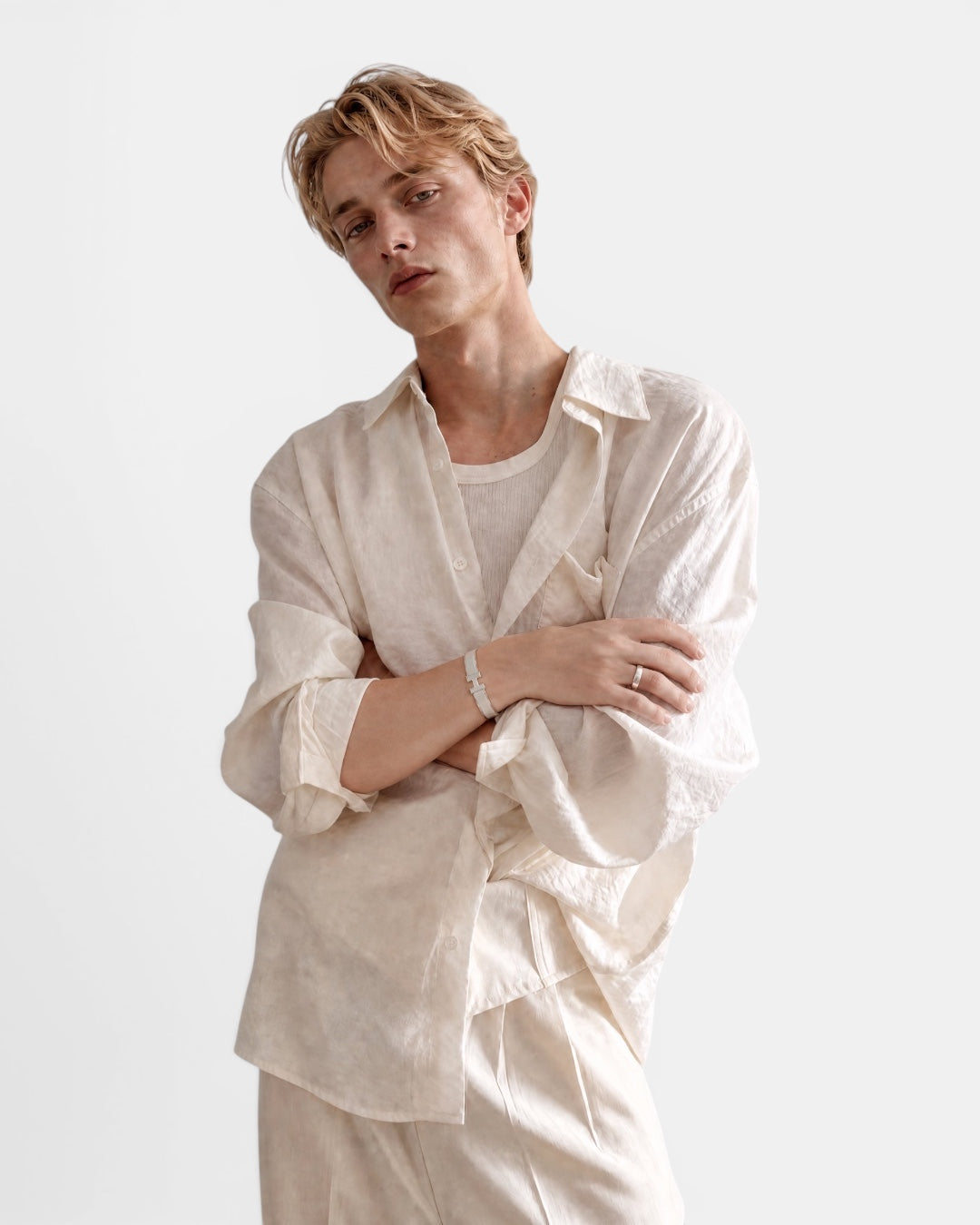 NAMELESS cream textured long sleeve linen shirt worn by a male model with arms crossed.