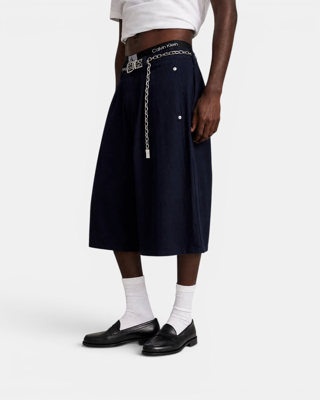 Nameless navy blue tailored wide-leg culottes with a silver chain belt and Calvin Klein waistband.