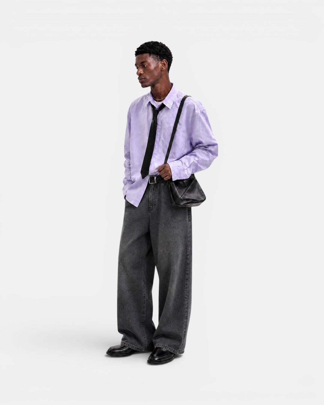 Nameless light purple solid-color long-sleeved linen shirt with a black tie, worn by a male model with dark grey wide-leg jeans and black loafers.