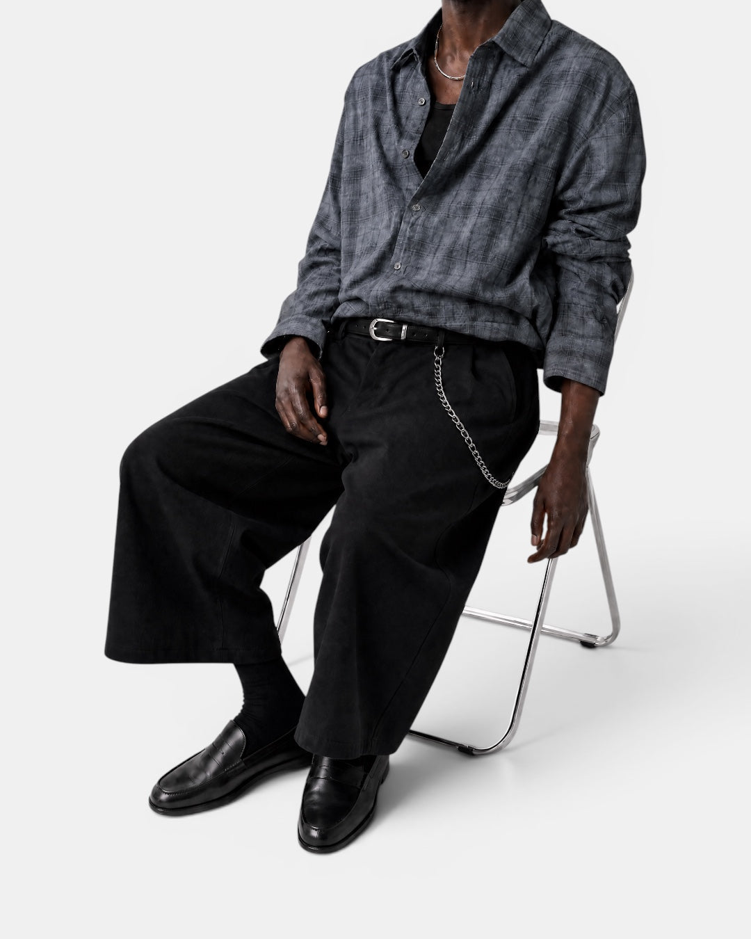 Nameless vintage textured grey checkered long-sleeve shirt worn by a man sitting on a chair.